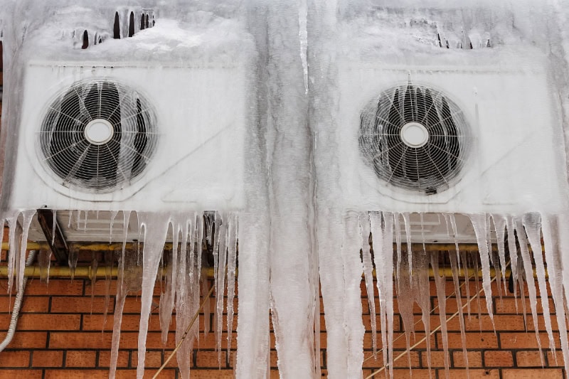 Is Your Thermostat Causing Your AC to Freeze Up in Midway? External air conditioning system in ice.